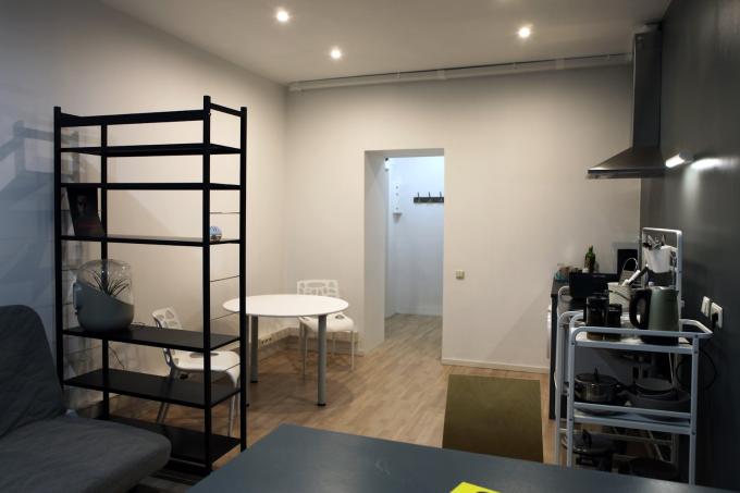 Residency Apartment Riga 2, a room with a shelf, a table and a kitchen area