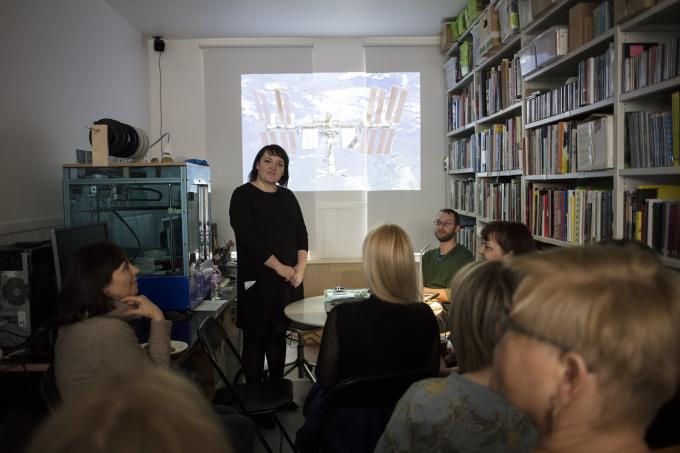 Mediatheque, a room filled with people and shelves with bookd and media